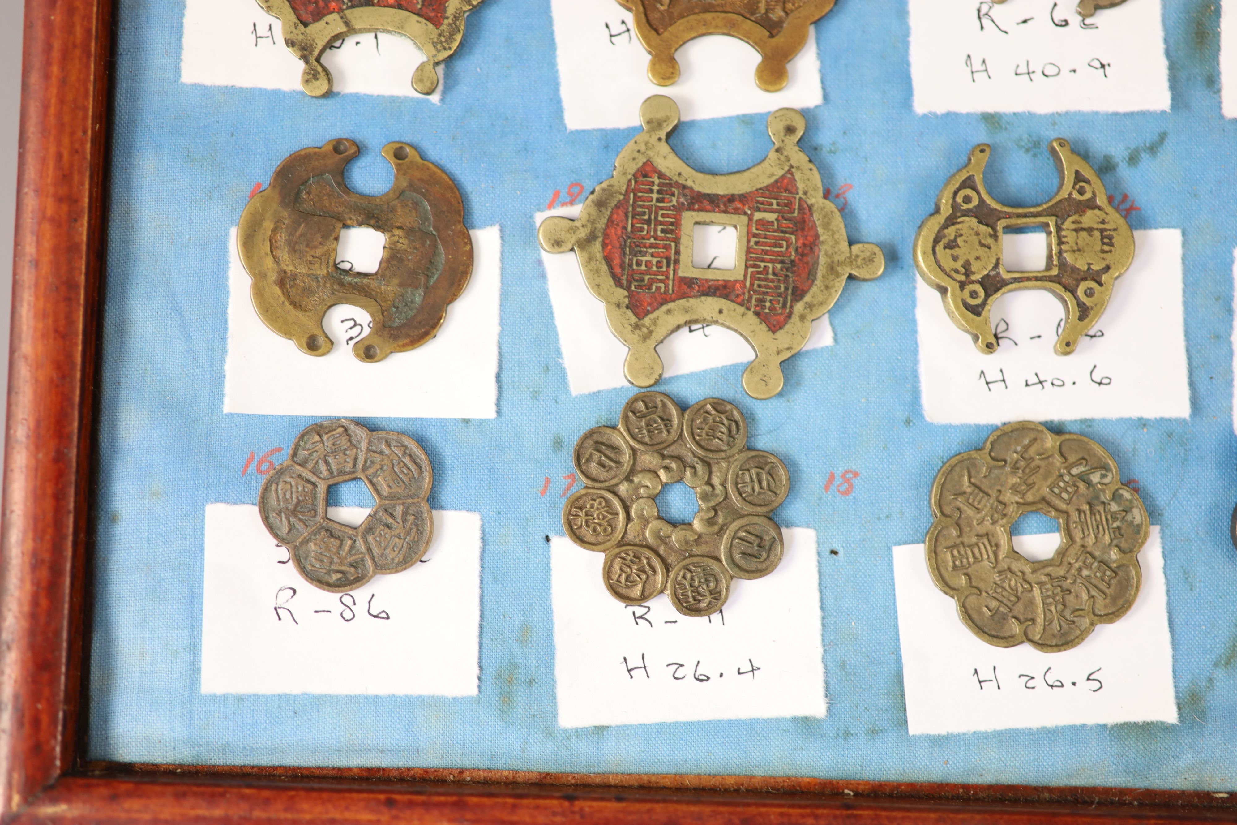 A group of 99 Korean bronze and metal amulets or charms, 19th/20th century